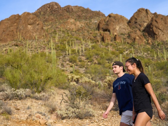 Students hike the trail at Gates Pass as the sun sets. Photo taken during 160over90 Arizona master brand photo shoot, March 2022.